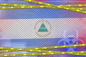 Nicaragua flag and Covid-19 quarantine yellow tape. Coronavirus or 2019-nCov virus concept photo