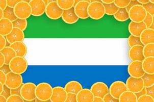 Sierra Leone flag in fresh citrus fruit slices frame photo