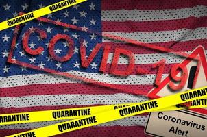 United States of America flag and Covid-19 quarantine yellow tape with red stamp. Coronavirus or 2019-nCov virus photo