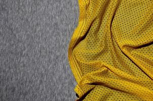 Top view of cloth textile surface. Close-up rumpled heater and knitted fabric texture with a thin striped pattern. Sport clothing fabric texture. Colored basketball shirt and heater hoodie photo