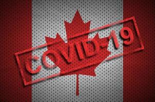 Canada flag and red Covid-19 stamp. Coronavirus 2019-nCov outbreak photo