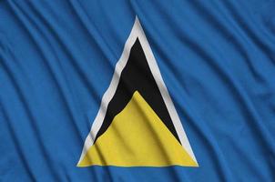 Saint Lucia flag is depicted on a sports cloth fabric with many folds. Sport team banner photo