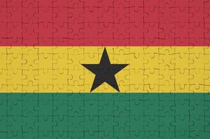 Ghana flag is depicted on a folded puzzle photo