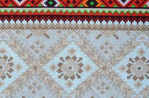 Traditional Ukrainian folk art knitted embroidery pattern on textile fabric photo