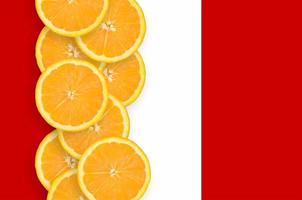 Peru flag and citrus fruit slices vertical row photo