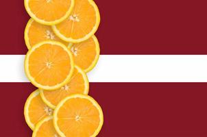 Latvia flag and citrus fruit slices vertical row photo