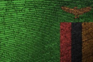 Zambia flag is depicted on the screen with the program code. The concept of modern technology and site development photo