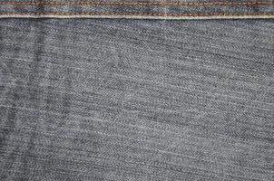 Detailed texture of dark denim cloth photo