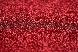 Crimson red decorative sequins. Background image with shiny bokeh lights from small elements photo