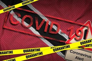 Trinidad and Tobago flag and Covid-19 quarantine yellow tape with red stamp. Coronavirus or 2019-nCov virus photo