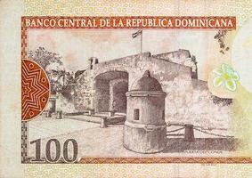 Puerta Del Conde building depicted on old one hundred peso note Dominican republic money photo