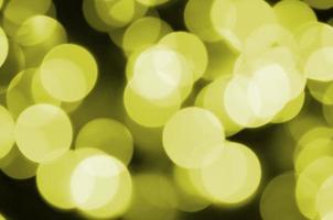 Bokeh effect golden yellow defocused light background. Christmas Lights Concept photo