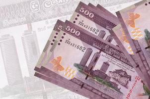 Los billetes de 500 rupias de Sri Lanka se encuentran apilados en el fondo de un gran billete semitransparente. presentación abstracta de la moneda nacional foto