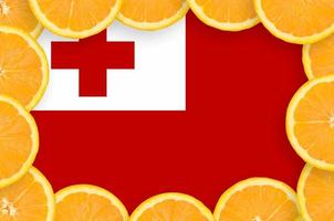 Tonga flag in fresh citrus fruit slices frame photo