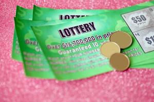 Close up view of green lottery scratch cards. Many used fake instant lottery tickets with gambling results. Gambling addiction photo