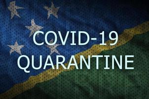 Solomon Islands flag and Covid-19 quarantine inscription. Coronavirus or 2019-nCov virus photo