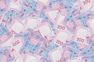 200 Ukrainian hryvnias bills lies in big pile. Rich life conceptual background photo