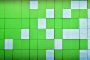 The texture of the metal wall, framed in the form of colored squares of two colors. Modern wall design for the exterior of residential and office buildings photo