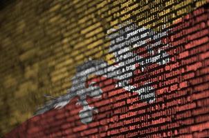 Bhutan flag is depicted on the screen with the program code. The concept of modern technology and site development photo