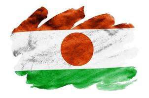 Niger flag is depicted in liquid watercolor style isolated on white background photo