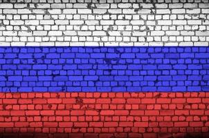 Russia flag is painted onto an old brick wall photo