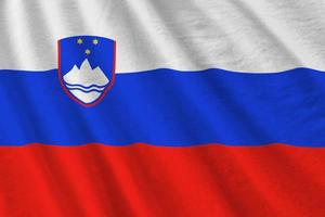 Slovenia flag with big folds waving close up under the studio light indoors. The official symbols and colors in banner photo