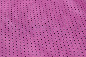Texture of sportswear made of polyester fiber. Outerwear for sports training has a mesh texture of stretchable nylon fabric photo