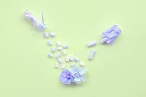 Concept of care for flowers. Violet flower sprinkled with marshmallows photo