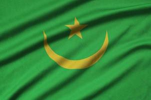 Mauritania flag is depicted on a sports cloth fabric with many folds. Sport team banner photo