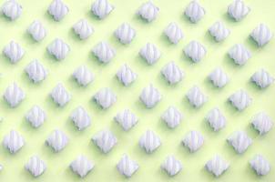 Colorful marshmallow laid out on lime paper background. pastel creative textured pattern photo