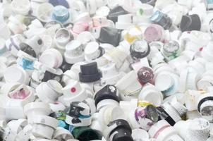 A pattern of many used and soiled nozzles from spray cans with aerosol paint. Background texture of the street art of drawing graffiti on the walls photo