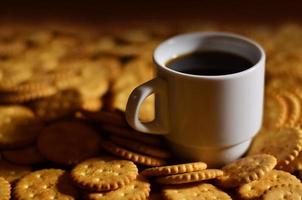 Small coffee cup and salted cracker photo