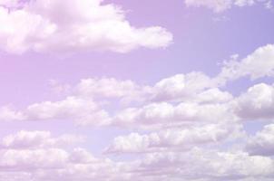 A blue sky with lots of white clouds of different sizes photo