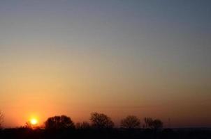 Dawn in the village. Sunrise in the suburban landscape photo