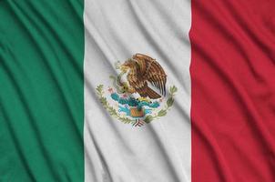 Mexico flag is depicted on a sports cloth fabric with many folds. Sport team banner photo