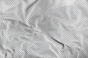 Sport clothing fabric texture background, top view of white cloth textile surface photo