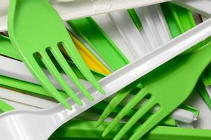 Pile of bright yellow, green and white used plastic kitchenware appliances photo