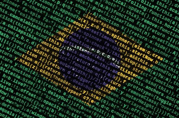 Brazil flag is depicted on the screen with the program code. The concept of modern technology and site development