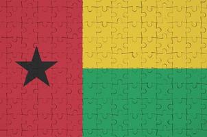 Guinea Bissau flag is depicted on a folded puzzle photo