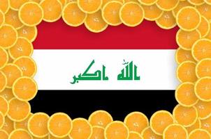 Iraq flag in fresh citrus fruit slices frame photo