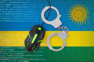 Rwanda flag and handcuffed computer mouse. Combating computer crime, hackers and piracy photo