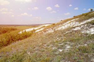 Ancient multimillion chalk mountains on the steppe surface of earth photo