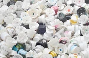 A pattern of many used and soiled nozzles from spray cans with aerosol paint. Background texture of the street art of drawing graffiti on the walls photo