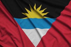 Antigua and Barbuda flag is depicted on a sports cloth fabric with many folds. Sport team banner photo