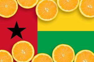 Guinea Bissau flag in citrus fruit slices horizontal frame photo