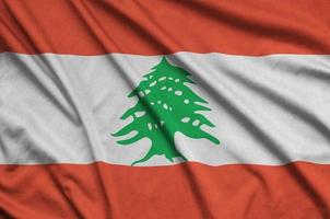 Lebanon flag is depicted on a sports cloth fabric with many folds. Sport team banner photo