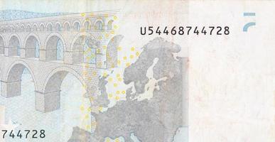 Fragment part of 5 euro banknote close-up with small brown details photo