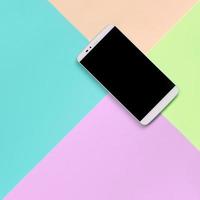 Modern smartphone with black screen on texture background of fashion pastel pink, blue, coral and lime colors photo