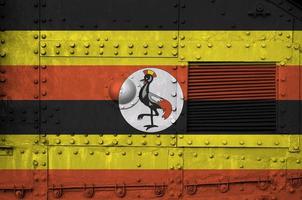 Uganda flag depicted on side part of military armored tank closeup. Army forces conceptual background photo