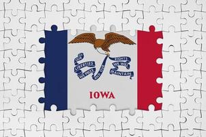 Iowa US state flag in frame of white puzzle pieces with missing central part photo